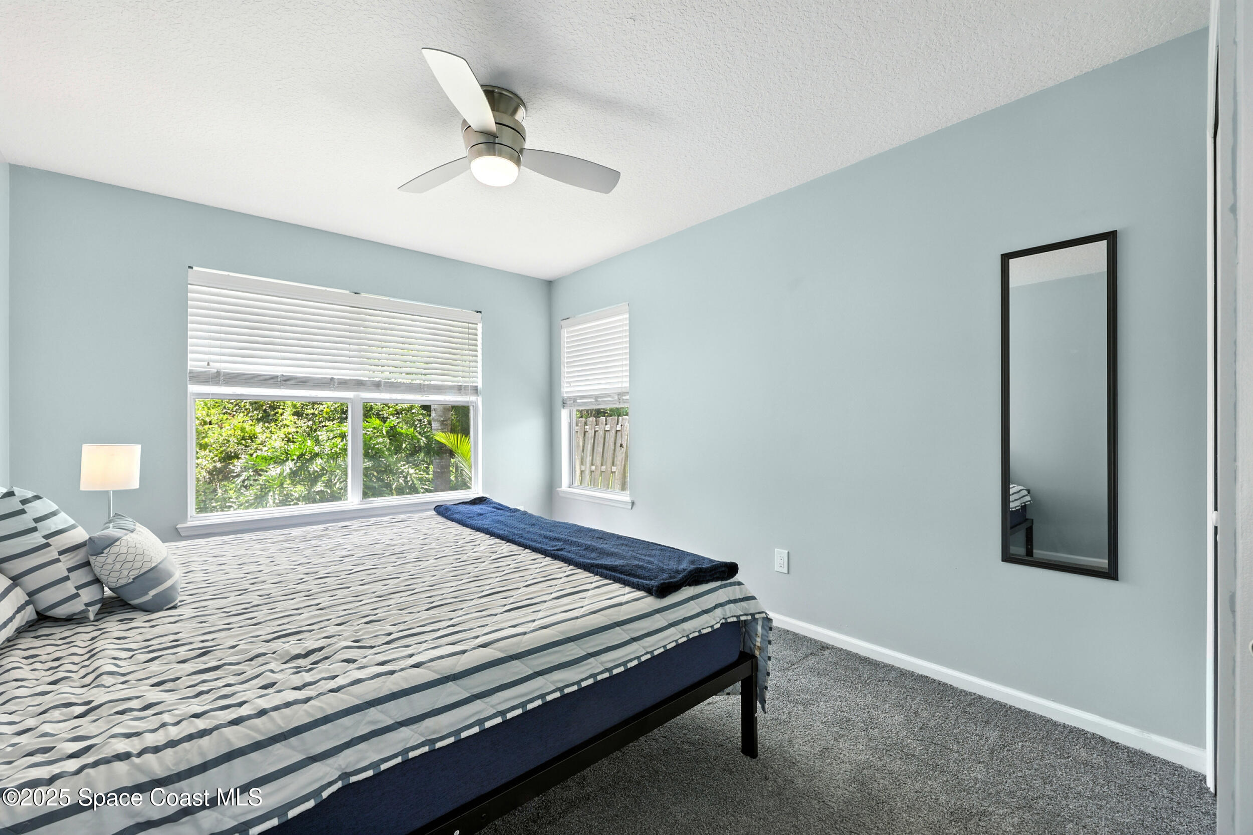 2560 Benjamin Road Jacksonville, FL 32223 - Photo 35 of 48 a bed sitting in a room next to a window