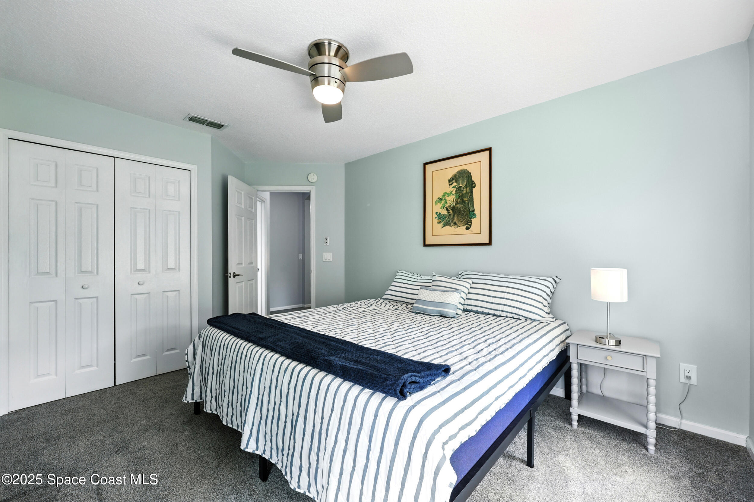2560 Benjamin Road Jacksonville, FL 32223 - Photo 36 of 48 a bedroom with a bed and a chandelier