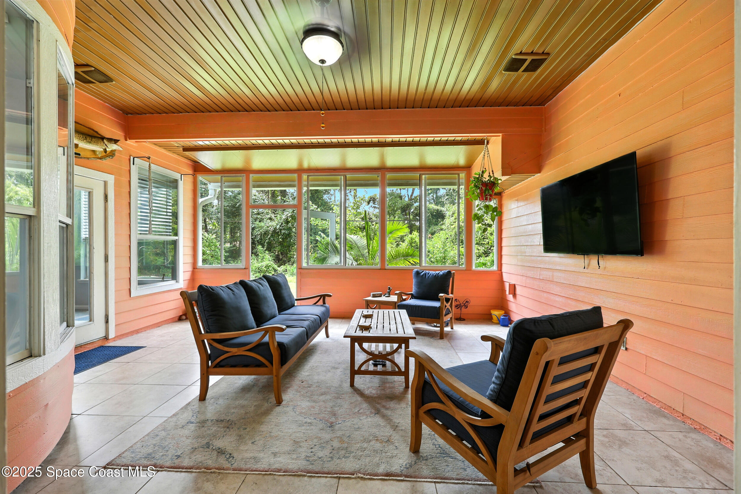 2560 Benjamin Road Jacksonville, FL 32223 - Photo 38 of 48 a outdoor living space with furniture and flat screen tv