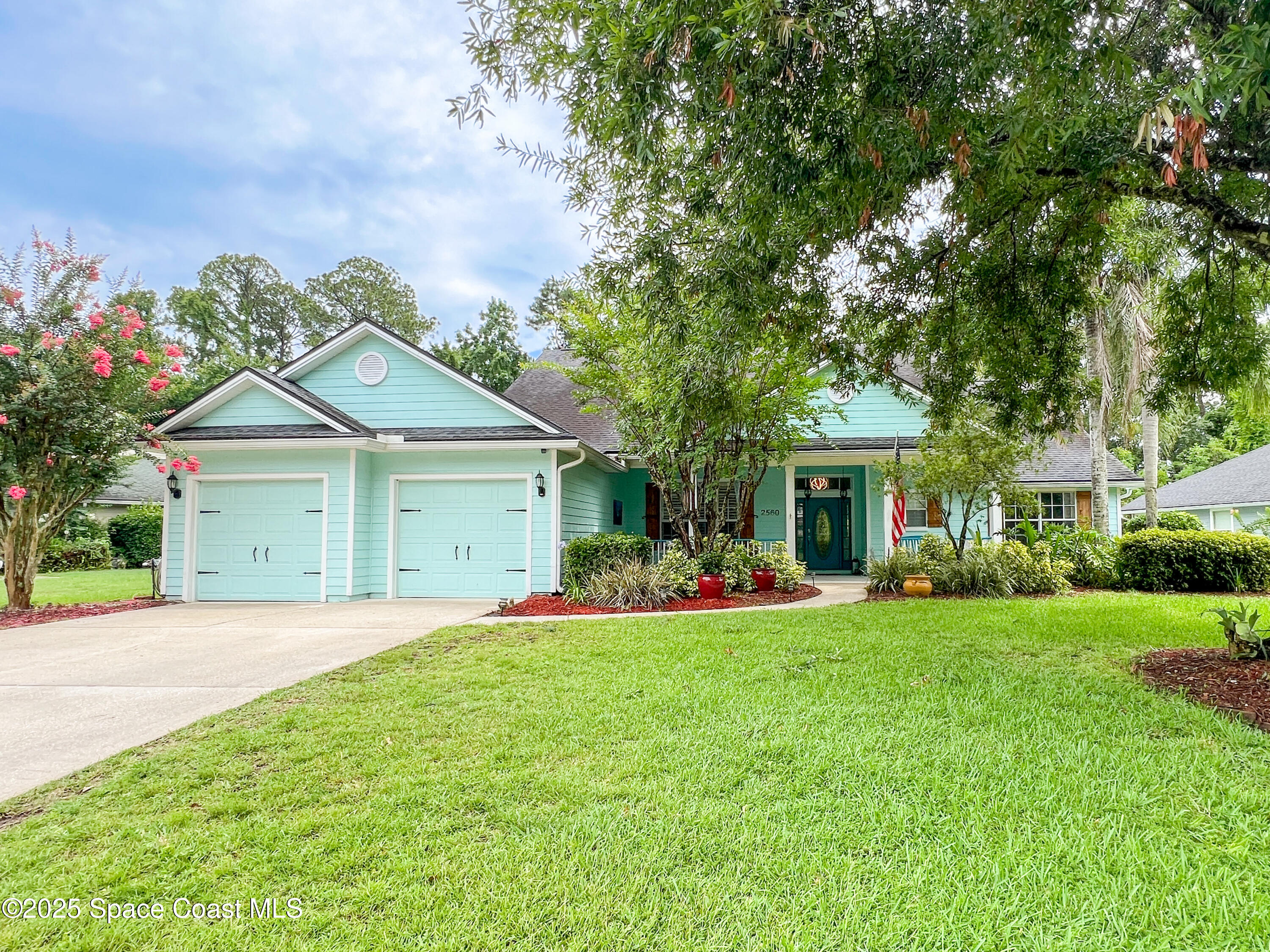 2560 Benjamin Road Jacksonville, FL 32223 - Photo 45 of 48 a front view of a house with a yard and garage