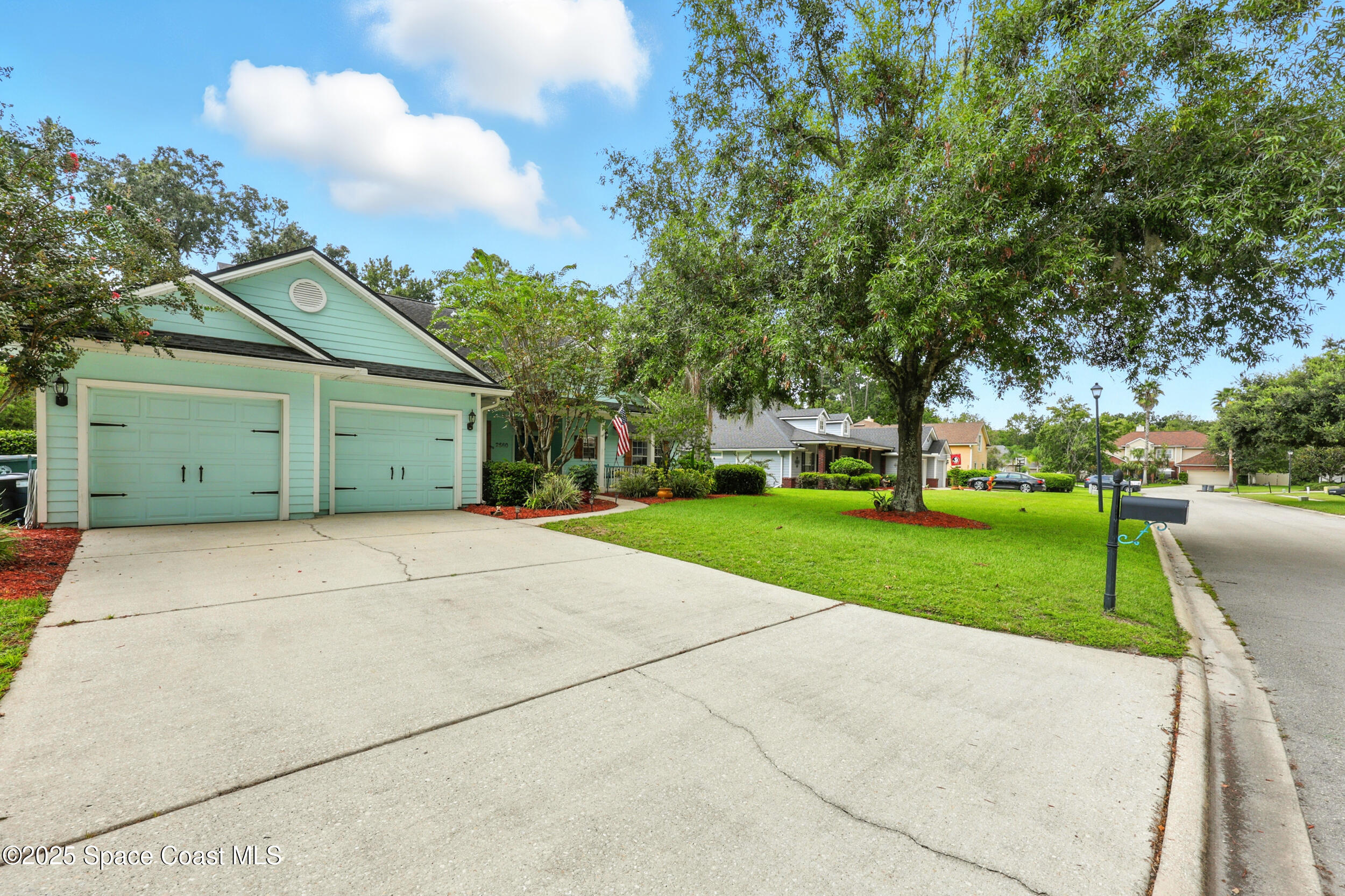 2560 Benjamin Road Jacksonville, FL 32223 - Photo 48 of 48 a view of a house with a yard and large trees