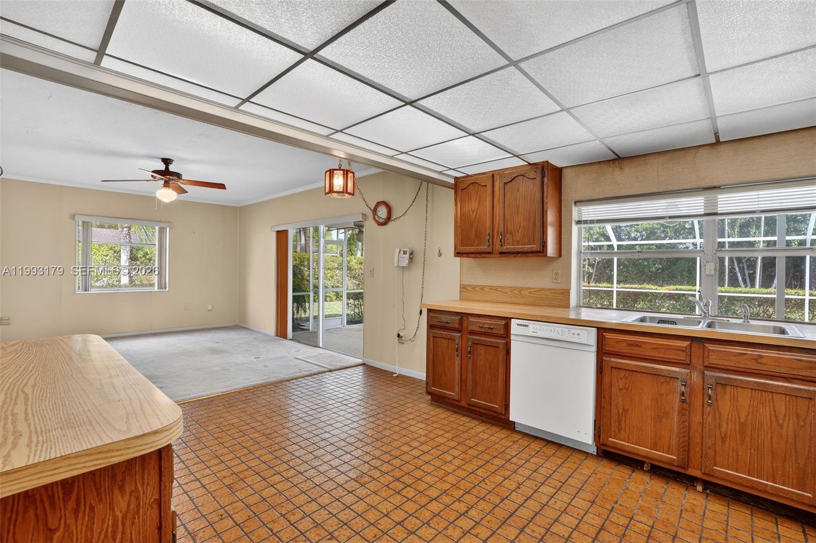 10753 Southwest 118th Street Miami, FL 33176 - Photo 11 of 51 a large kitchen with stainless steel appliances granite countertop a sink dishwasher stove and wooden cabinets
