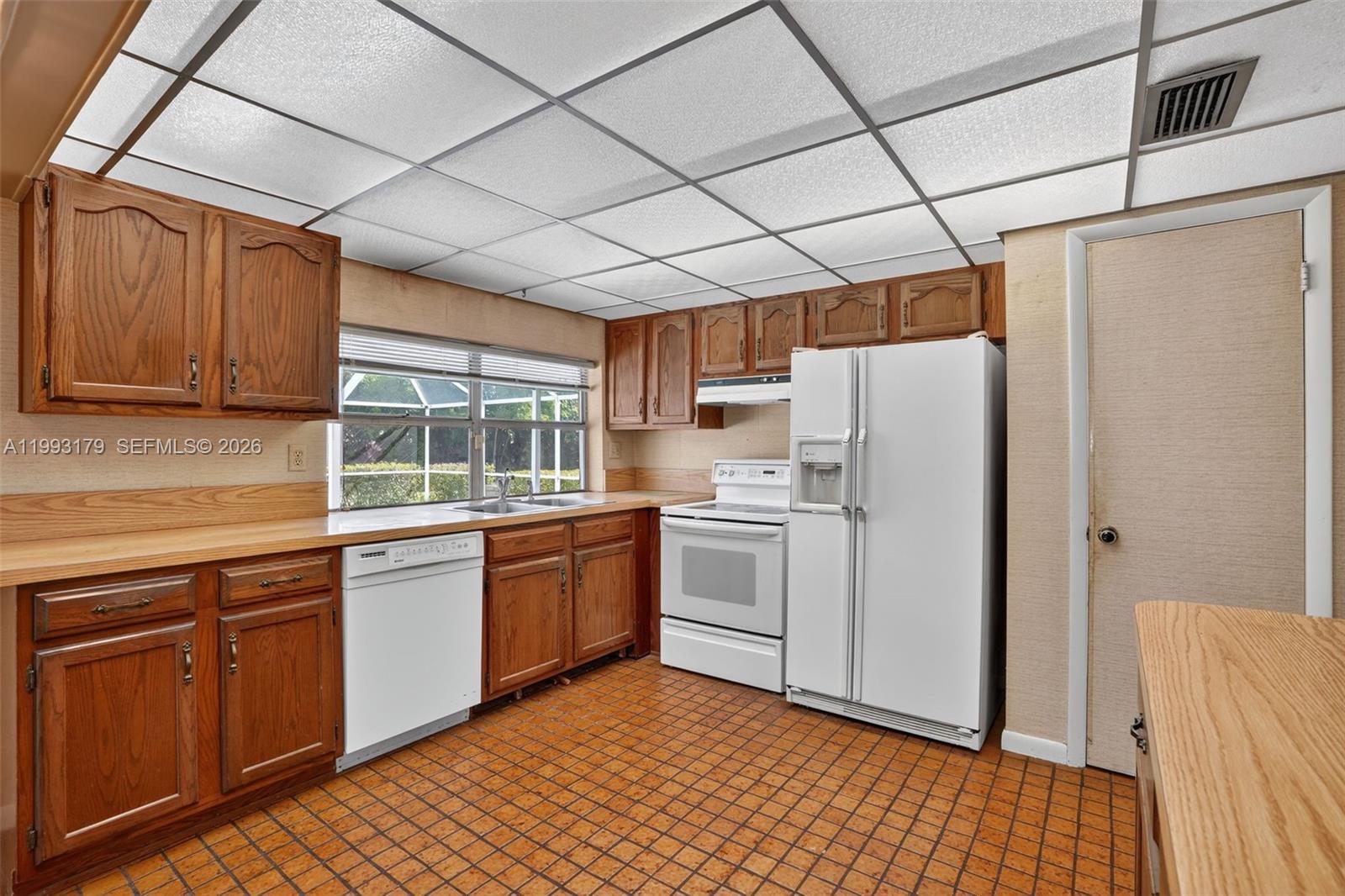 10753 Southwest 118th Street Miami, FL 33176 - Photo 13 of 51 a kitchen with granite countertop appliances a sink and cabinets