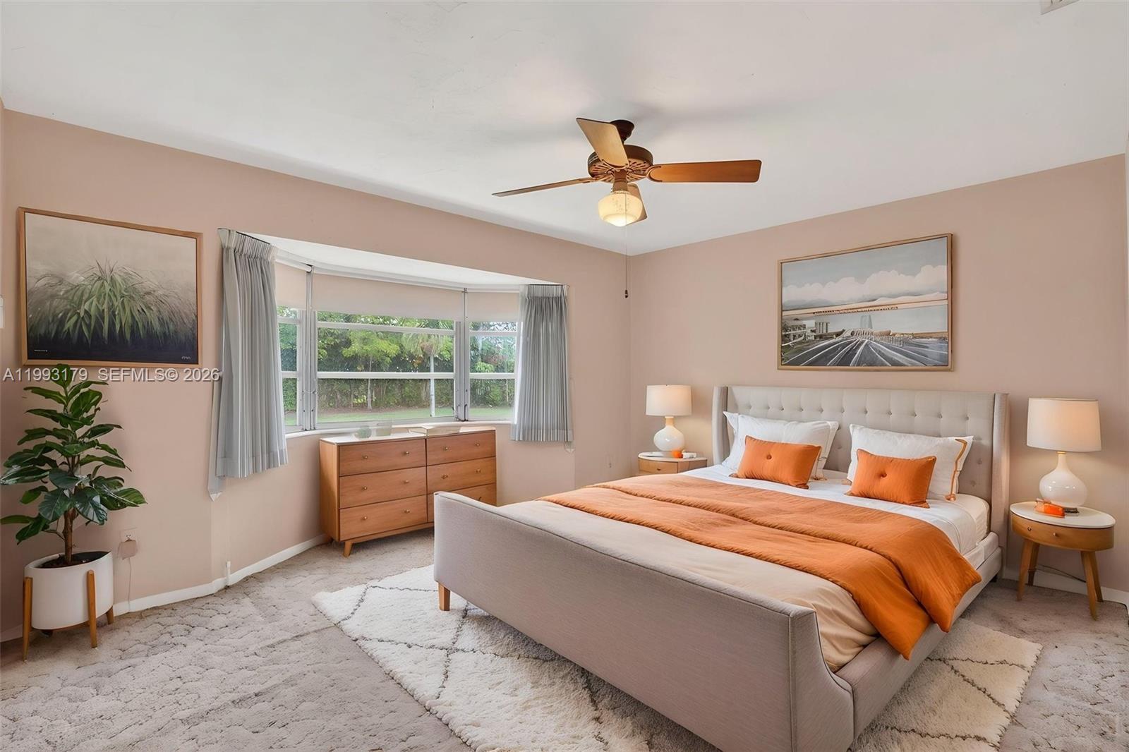 10753 Southwest 118th Street Miami, FL 33176 - Photo 20 of 51 a bedroom with a large bed and a potted plant