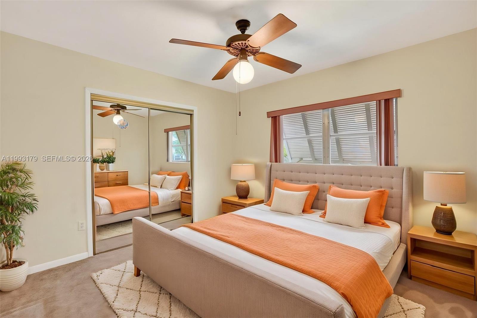 10753 Southwest 118th Street Miami, FL 33176 - Photo 27 of 51 a bedroom with a bed and a chandelier