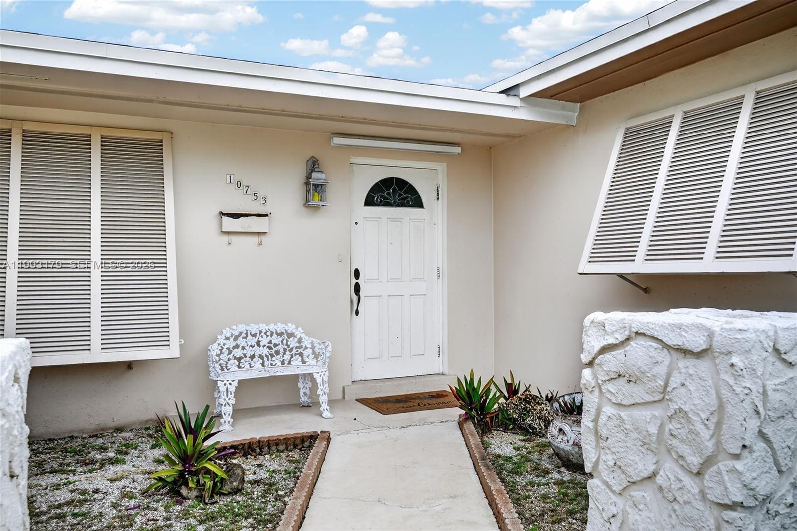 10753 Southwest 118th Street Miami, FL 33176 - Photo 3 of 51 a front view of a house with entryway