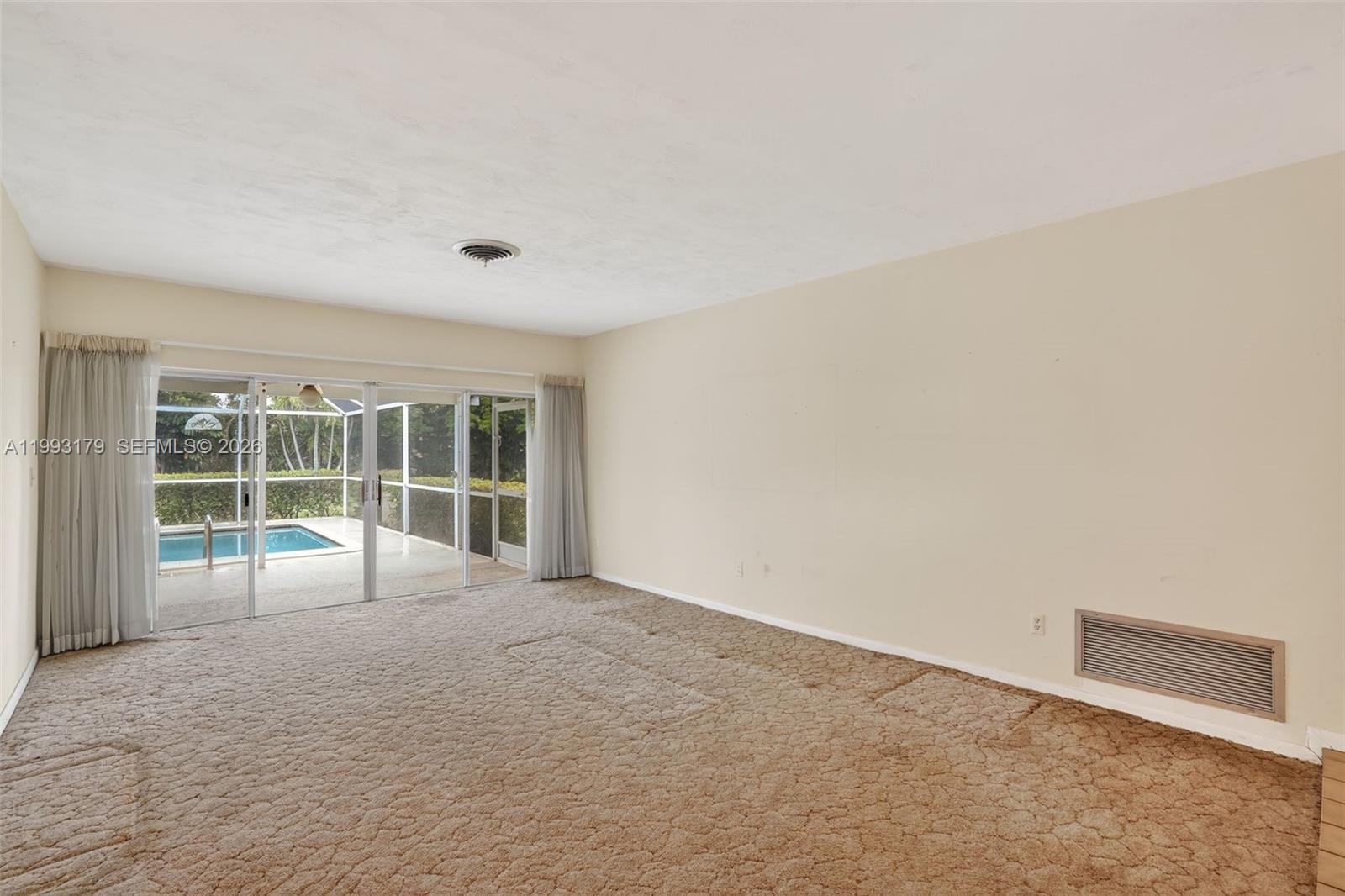 10753 Southwest 118th Street Miami, FL 33176 - Photo 6 of 51 an empty room with wooden floor and windows