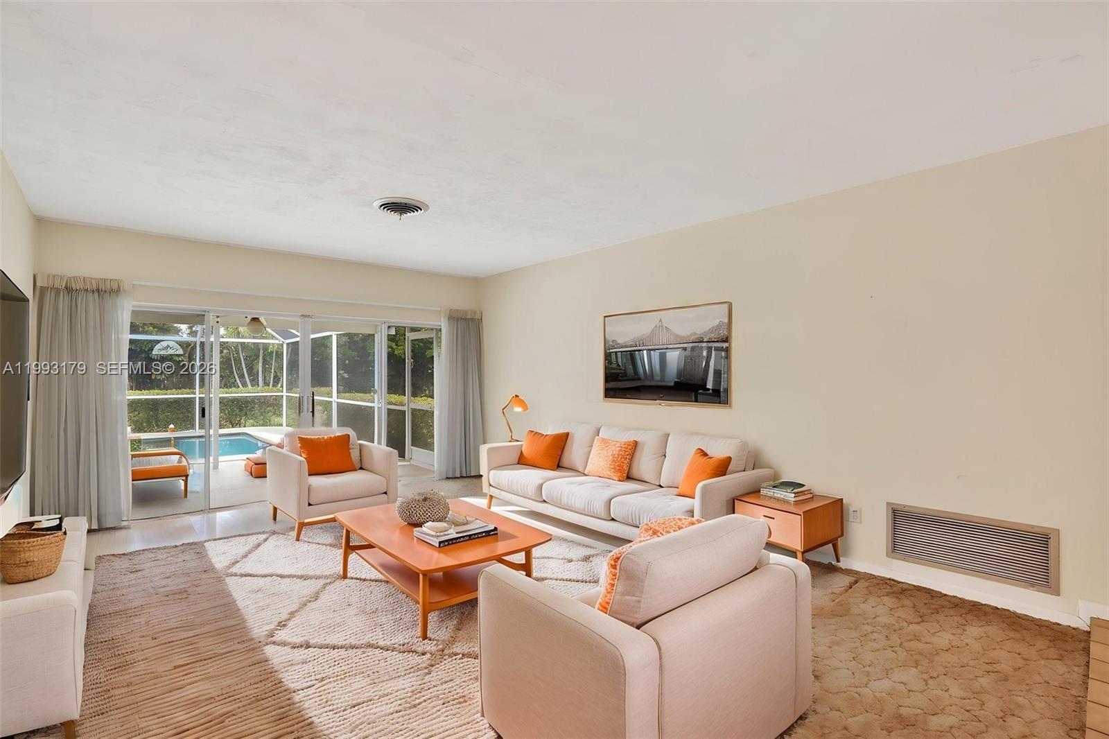 10753 Southwest 118th Street Miami, FL 33176 - Photo 7 of 51 a living room with furniture and a flat screen tv