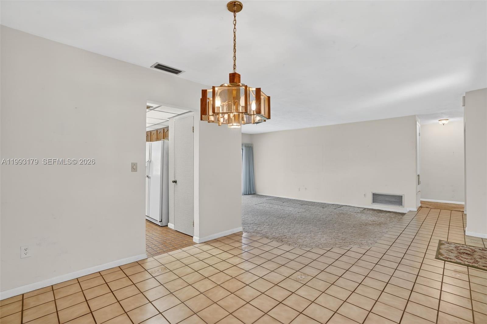 10753 Southwest 118th Street Miami, FL 33176 - Photo 10 of 51 a view of a room with a chandelier fan and windows