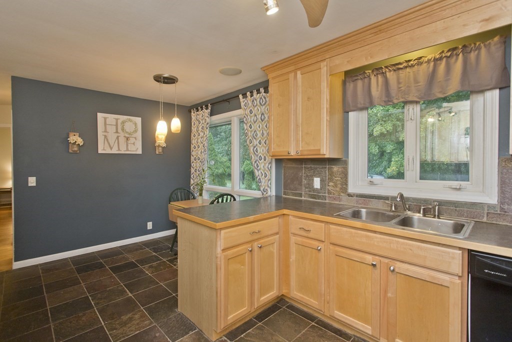73 Bremen Street Springfield, MA 01108 - Photo 11 of 42 a kitchen with stainless steel appliances a sink window and cabinets