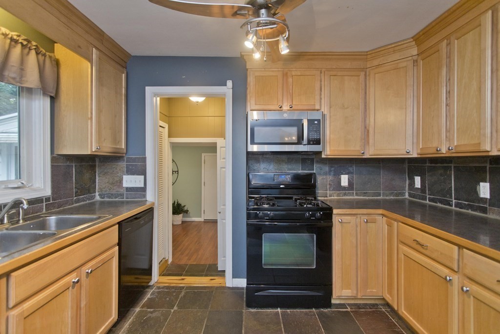73 Bremen Street Springfield, MA 01108 - Photo 13 of 42 a kitchen with stainless steel appliances a stove a sink and a microwave