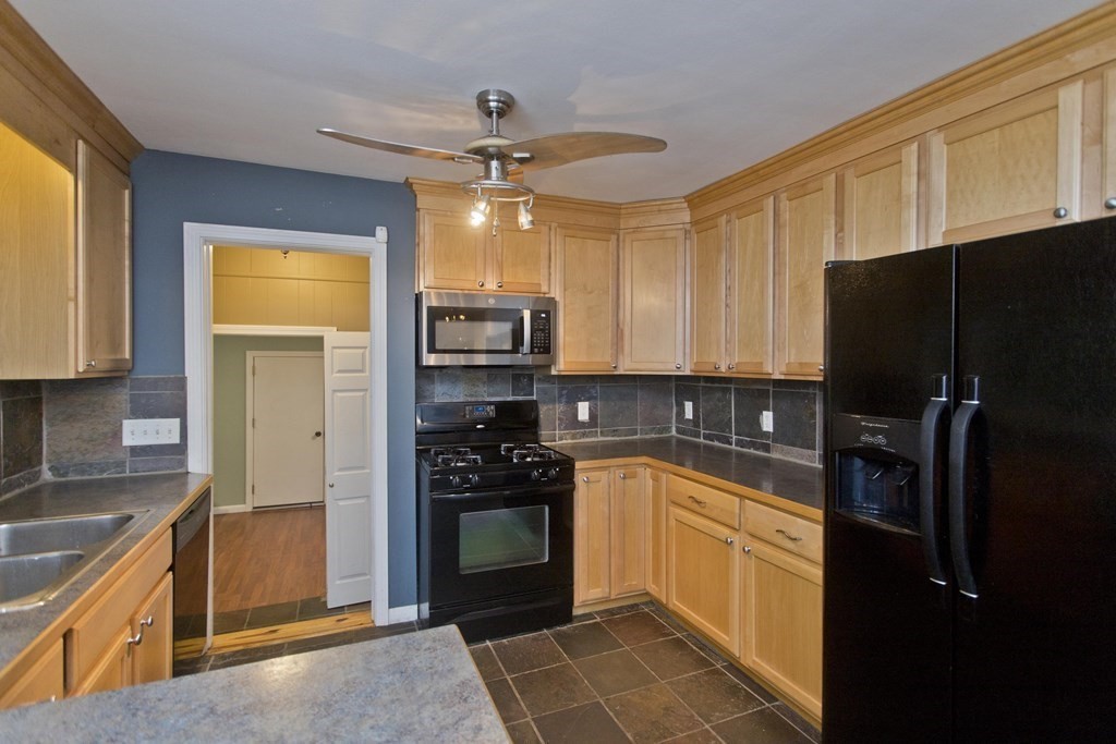 73 Bremen Street Springfield, MA 01108 - Photo 15 of 42 a kitchen with granite countertop a refrigerator and a stove top oven