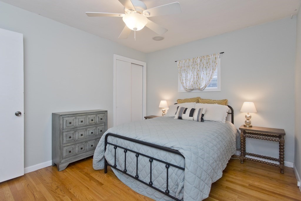 73 Bremen Street Springfield, MA 01108 - Photo 19 of 42 a bedroom with a bed and a chandelier