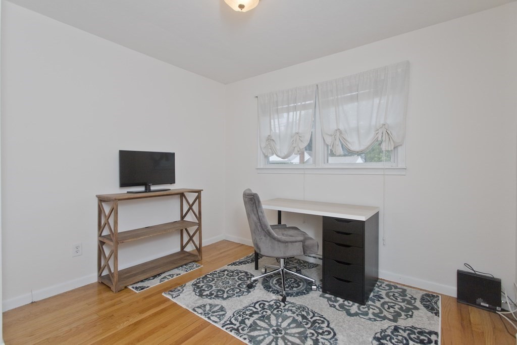 73 Bremen Street Springfield, MA 01108 - Photo 24 of 42 a work room with furniture a rug and a window