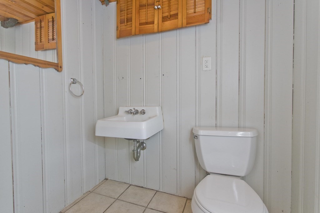73 Bremen Street Springfield, MA 01108 - Photo 36 of 42 a bathroom with a toilet a sink and mirror