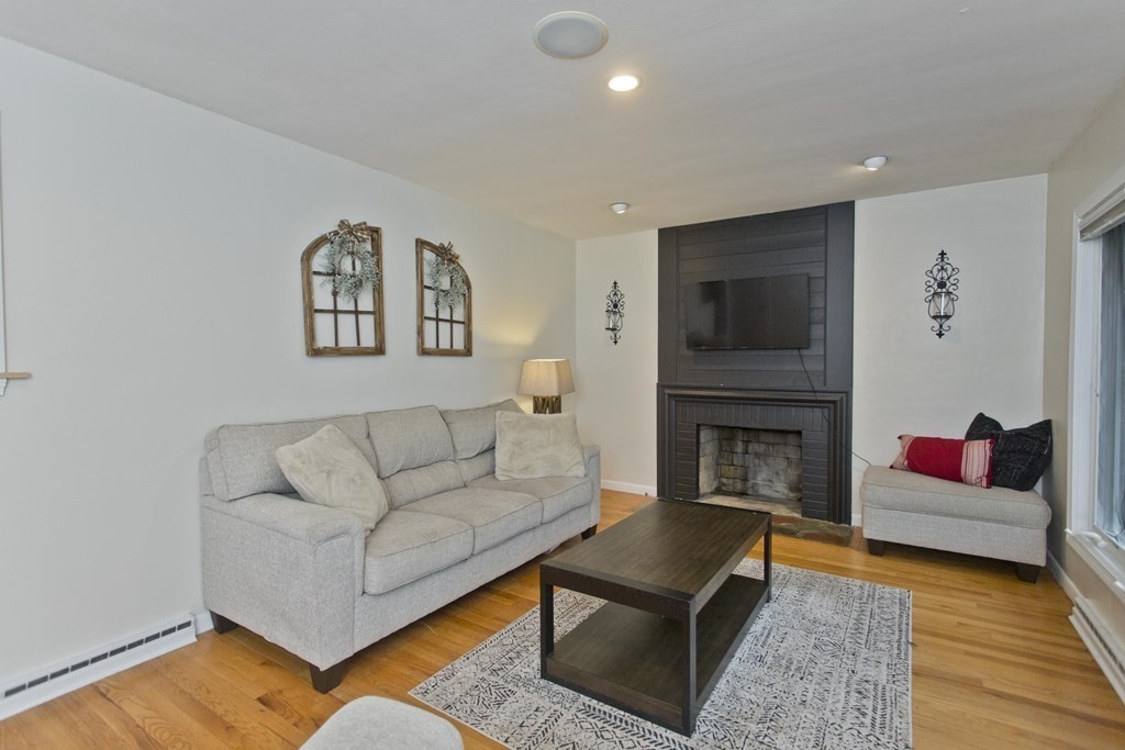73 Bremen Street Springfield, MA 01108 - Photo 5 of 42 a living room with furniture and a fireplace
