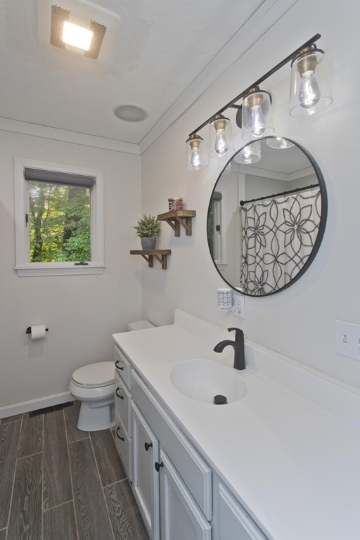 73 Bremen Street Springfield, MA 01108 - Photo 8 of 42 a bathroom with a sink mirror and toilet