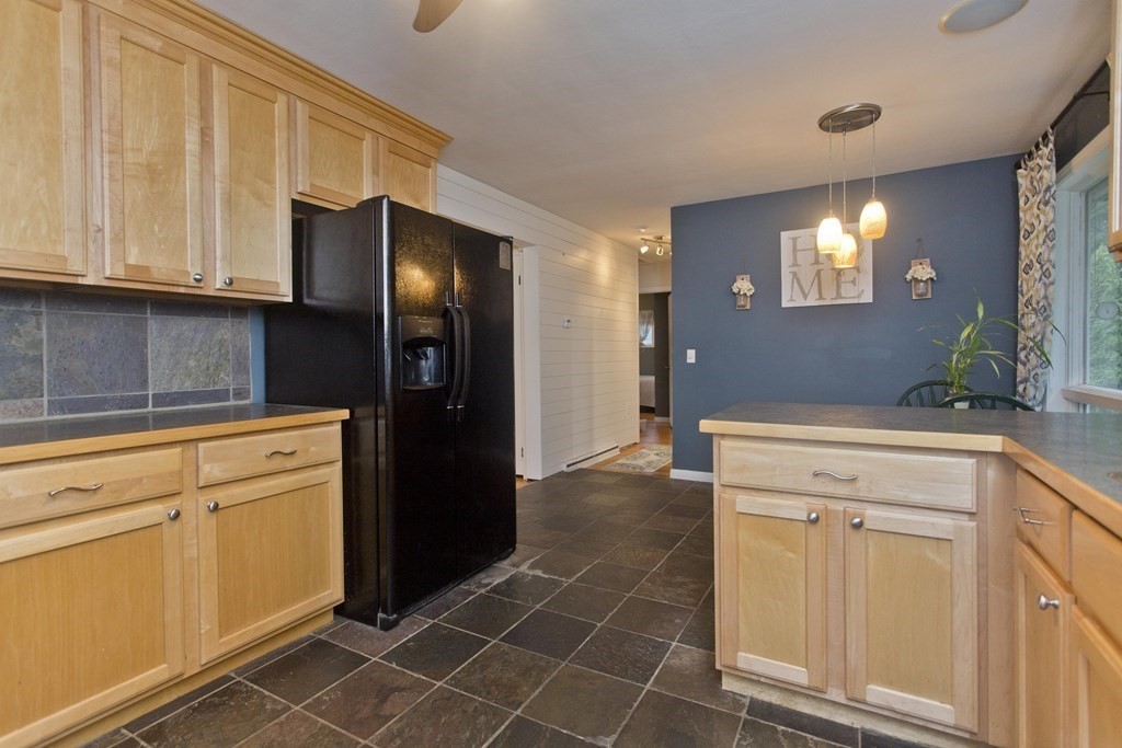 73 Bremen Street Springfield, MA 01108 - Photo 10 of 42 a kitchen with a refrigerator and cabinets