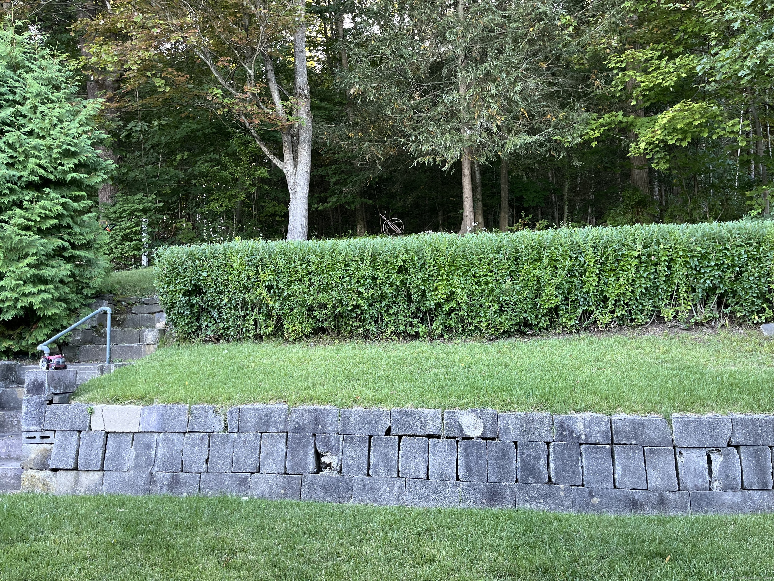 213 Spring Street Torrington, CT 06790 - Photo 24 of 25 a view of a yard with a wooden fence