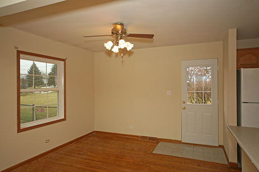 N141 Prince Crossing Road West Chicago, IL 60185 - Photo 4 of 13 a view of empty room with wooden floor and fan
