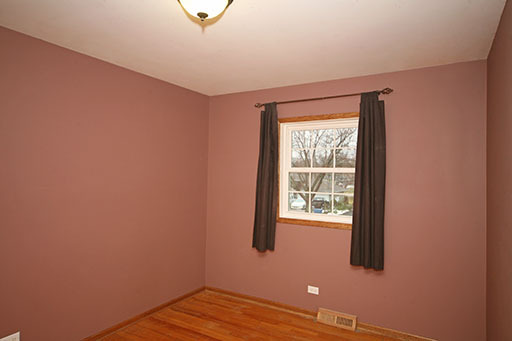N141 Prince Crossing Road West Chicago, IL 60185 - Photo 8 of 13 a view of an empty room with wooden floor and a window