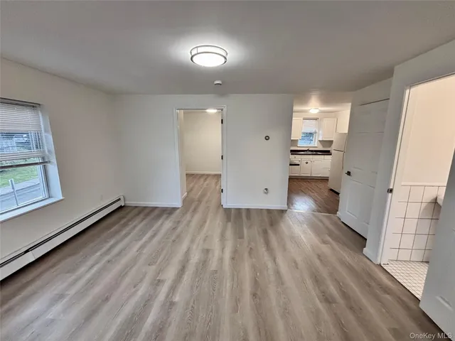 a view of a bedroom with wooden floor
