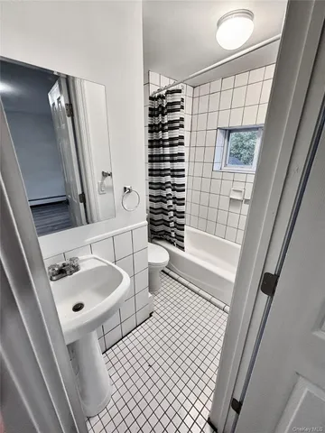 a bathroom with a bathtub and shower