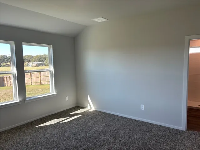 an empty room with a empty space and windows