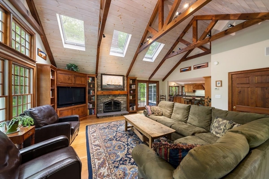 94 Middleton Road Boxford, MA 01921 - Photo 14 of 36 a living room with furniture a fireplace and a flat screen tv