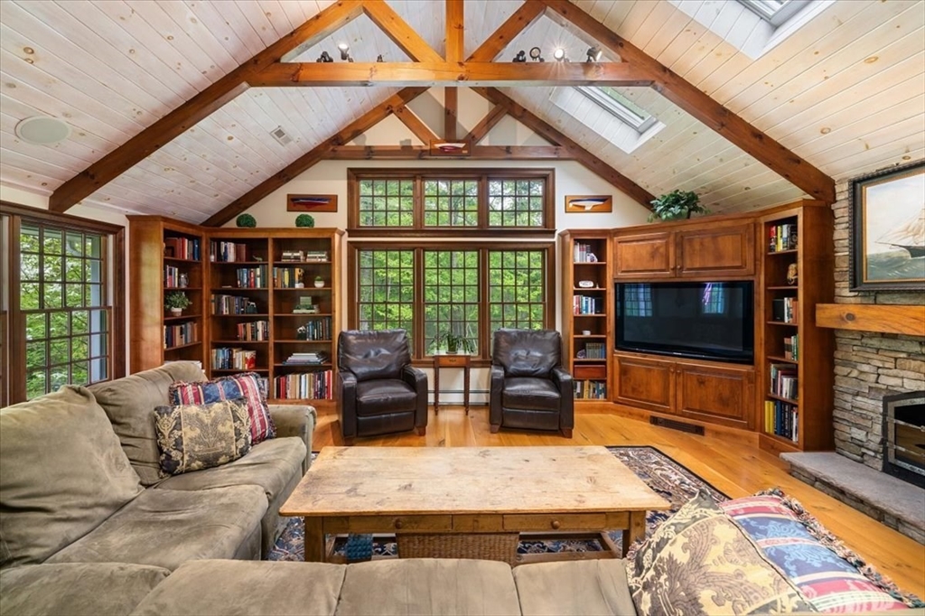 94 Middleton Road Boxford, MA 01921 - Photo 18 of 36 a living room with furniture a flat screen tv and a floor to ceiling window