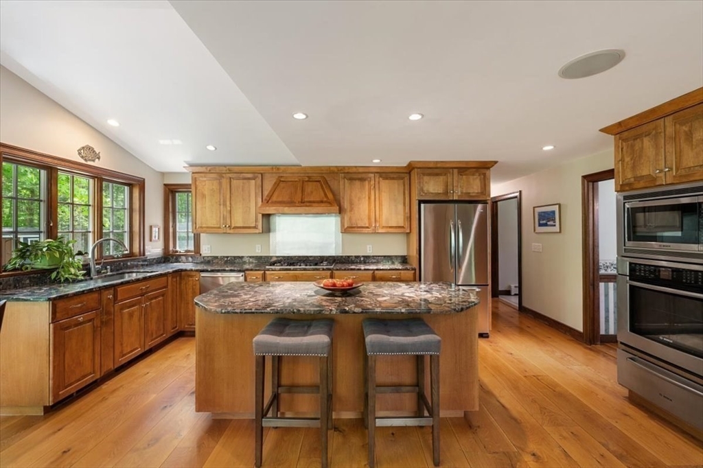 94 Middleton Road Boxford, MA 01921 - Photo 19 of 36 a kitchen with stainless steel appliances granite countertop a stove a sink and a refrigerator