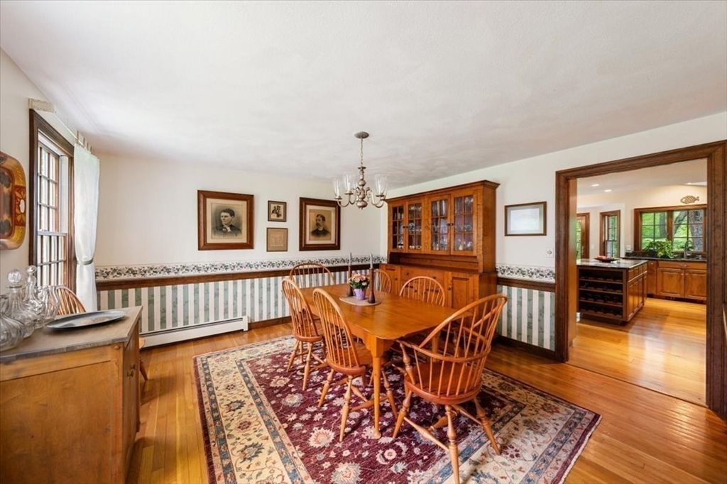 94 Middleton Road Boxford, MA 01921 - Photo 23 of 36 a dining room with furniture wooden floor a rug and a chandelier