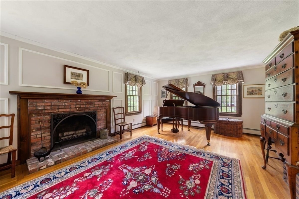 94 Middleton Road Boxford, MA 01921 - Photo 24 of 36 a living room with furniture a rug and a fireplace