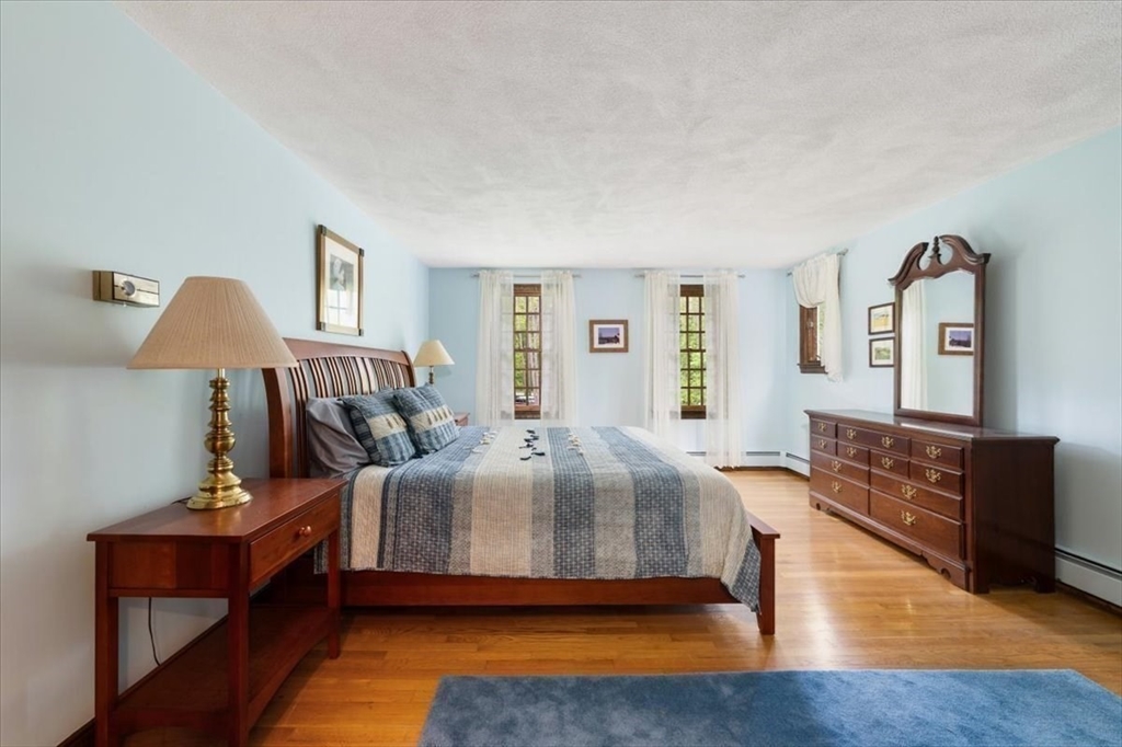94 Middleton Road Boxford, MA 01921 - Photo 25 of 36 a bedroom with a bed and wooden floor