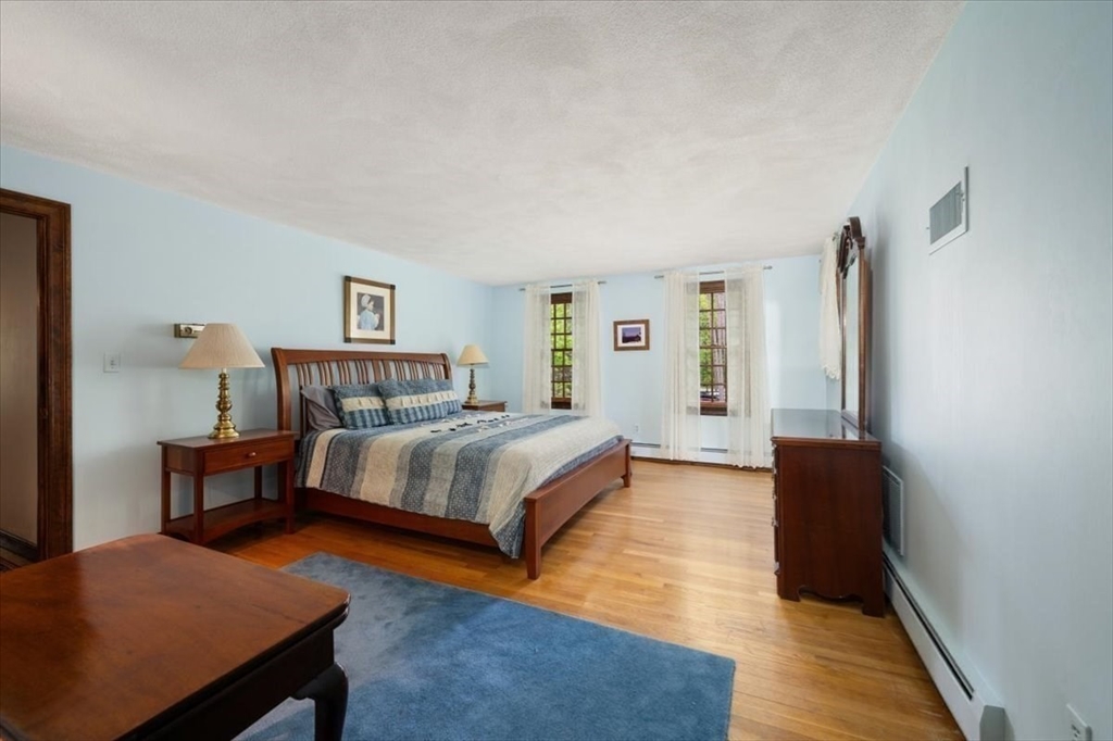 94 Middleton Road Boxford, MA 01921 - Photo 26 of 36 a bedroom with a bed and wooden floor