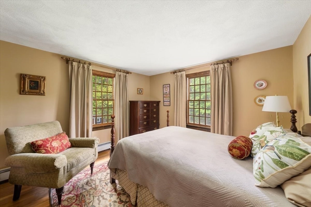 94 Middleton Road Boxford, MA 01921 - Photo 30 of 36 a bedroom with a bed and wooden floor