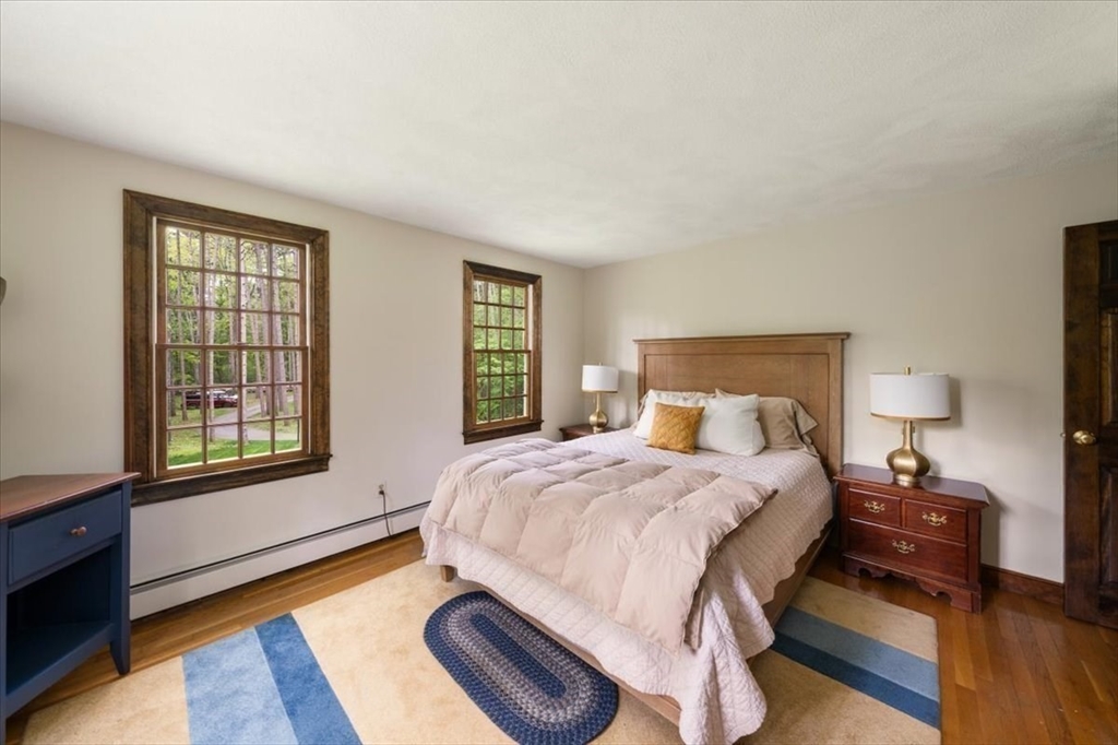 94 Middleton Road Boxford, MA 01921 - Photo 31 of 36 a bedroom with a bed and wooden floor