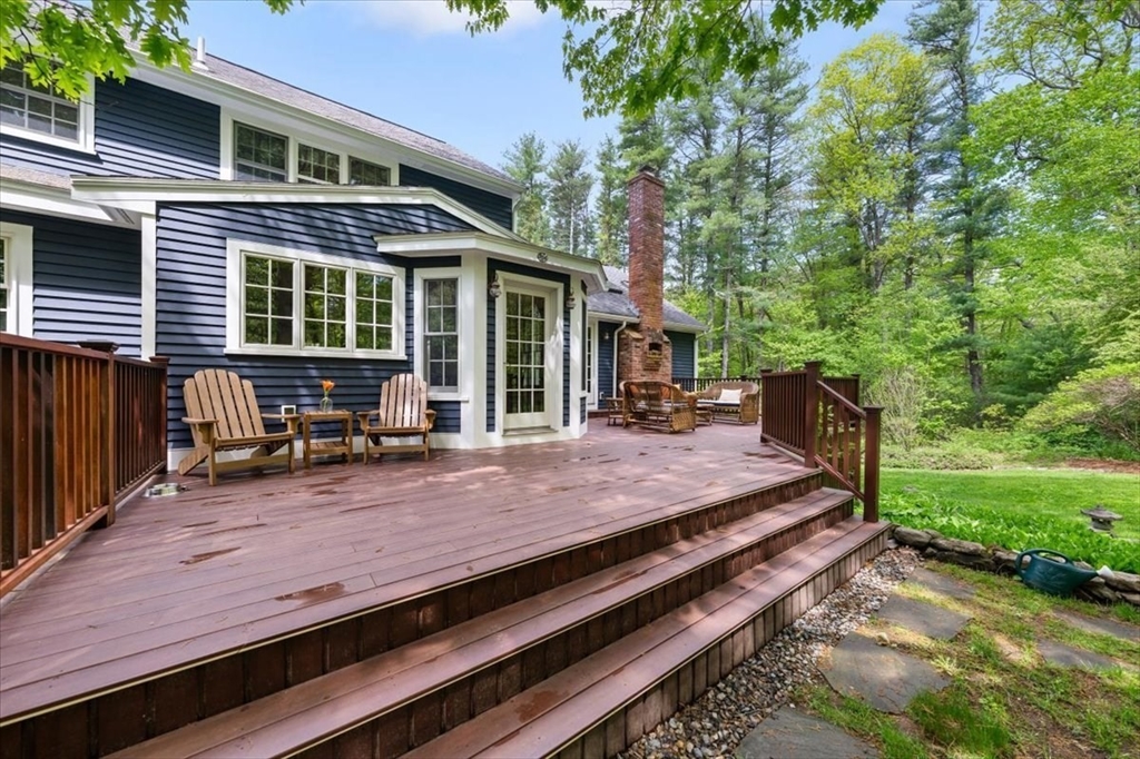 94 Middleton Road Boxford, MA 01921 - Photo 10 of 36 a view of a wooden deck with chairs and a yard
