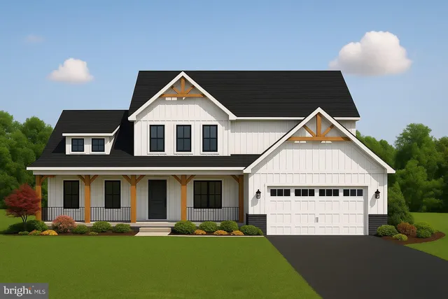 a front view of a house with a garden and yard