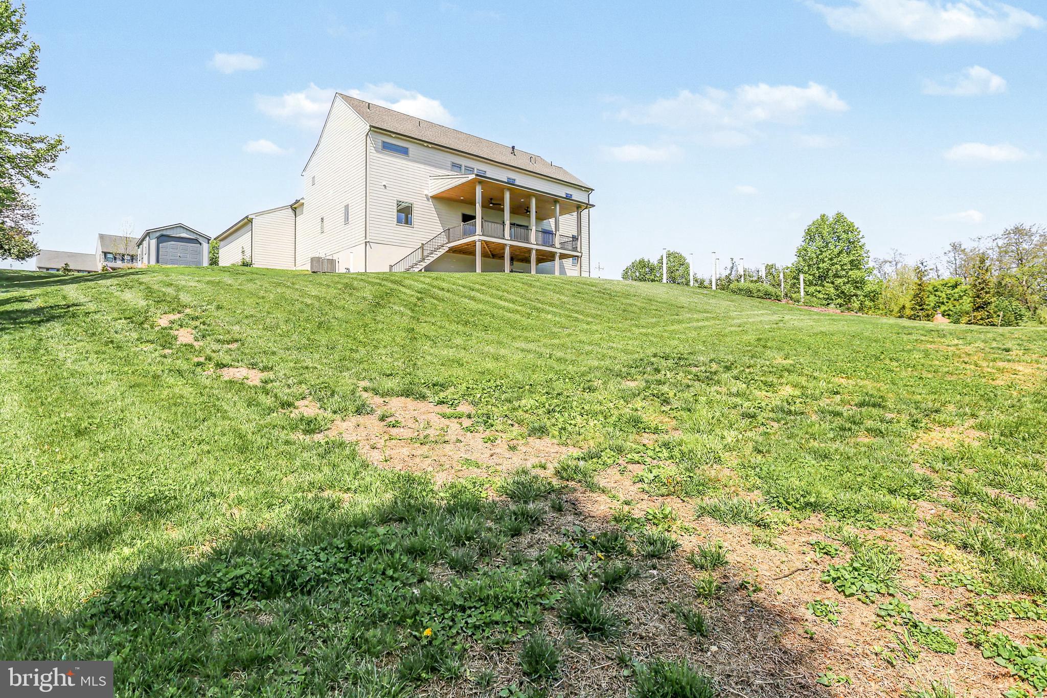 1 Strawberry Lane Lititz, PA 17543 - Photo 19 of 102 a backyard of a house with lots of green space and garden view