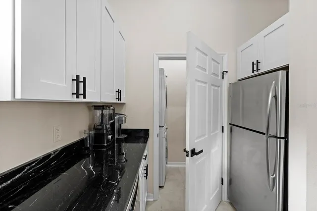 a view of a refrigerator and cabinets