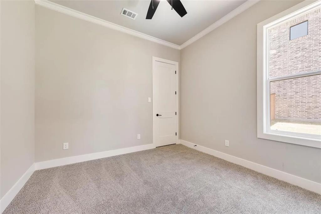 1327 Selby Road Van Alstyne, TX 75495 - Photo 18 of 32 Spare room featuring ornamental molding, light colored carpet, and ceiling fan