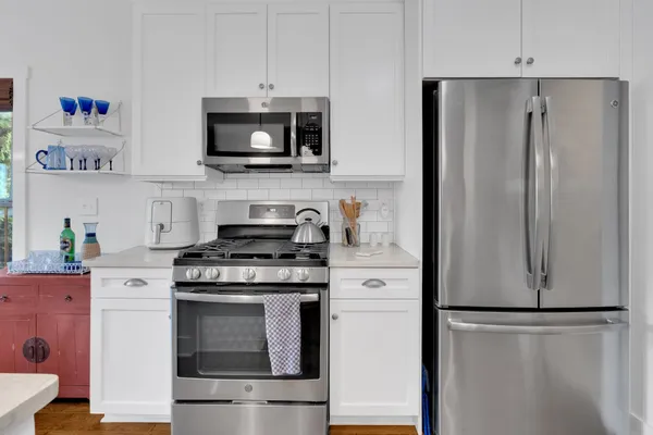 a kitchen with stainless steel appliances a refrigerator stove and microwave