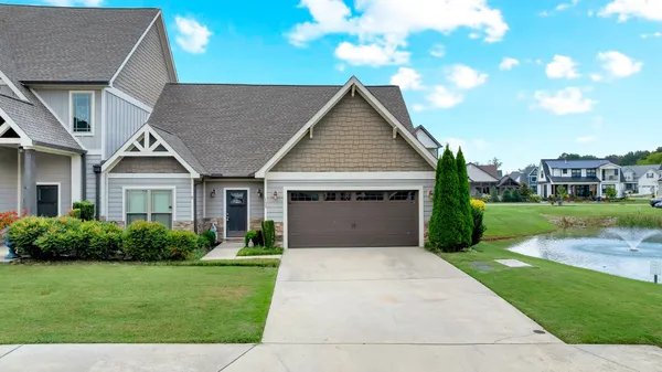 a front view of house with yard and green space