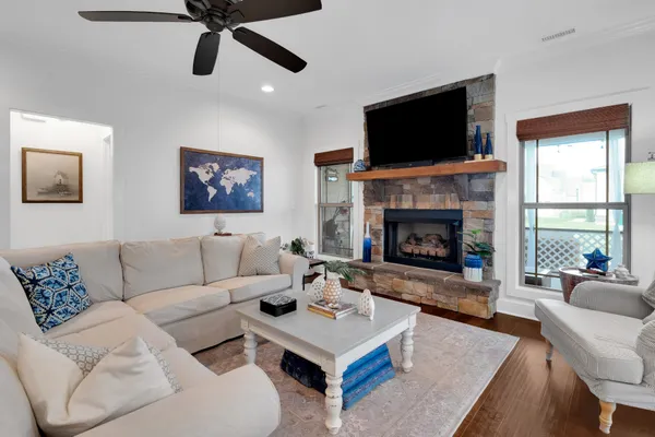 a living room with furniture fireplace and flat screen tv