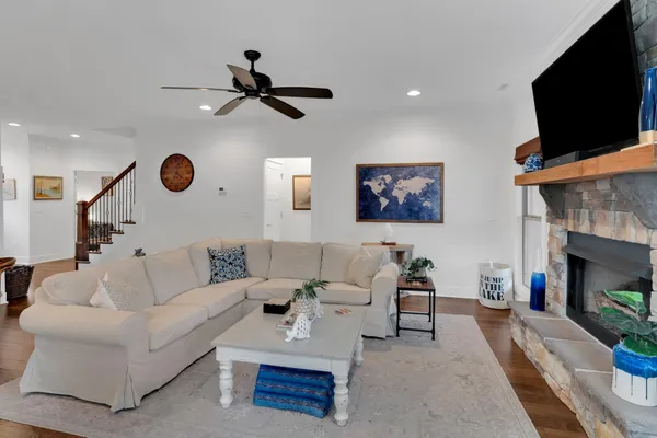 a living room with furniture a flat screen tv and a fireplace