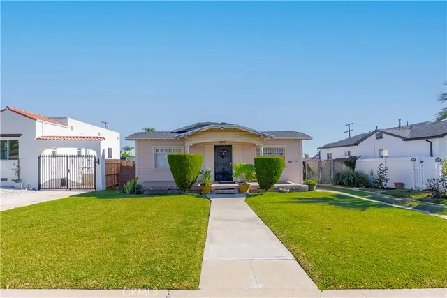 a view of a house with a yard and sitting area