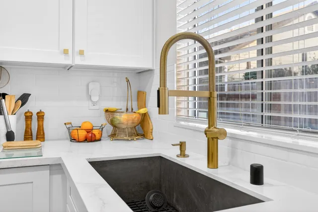 a kitchen with stainless steel appliances a refrigerator sink and a stove top oven