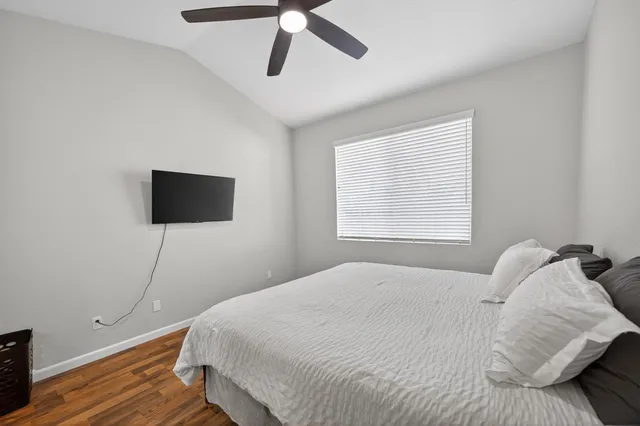 a bedroom with a bed and a ceiling fan