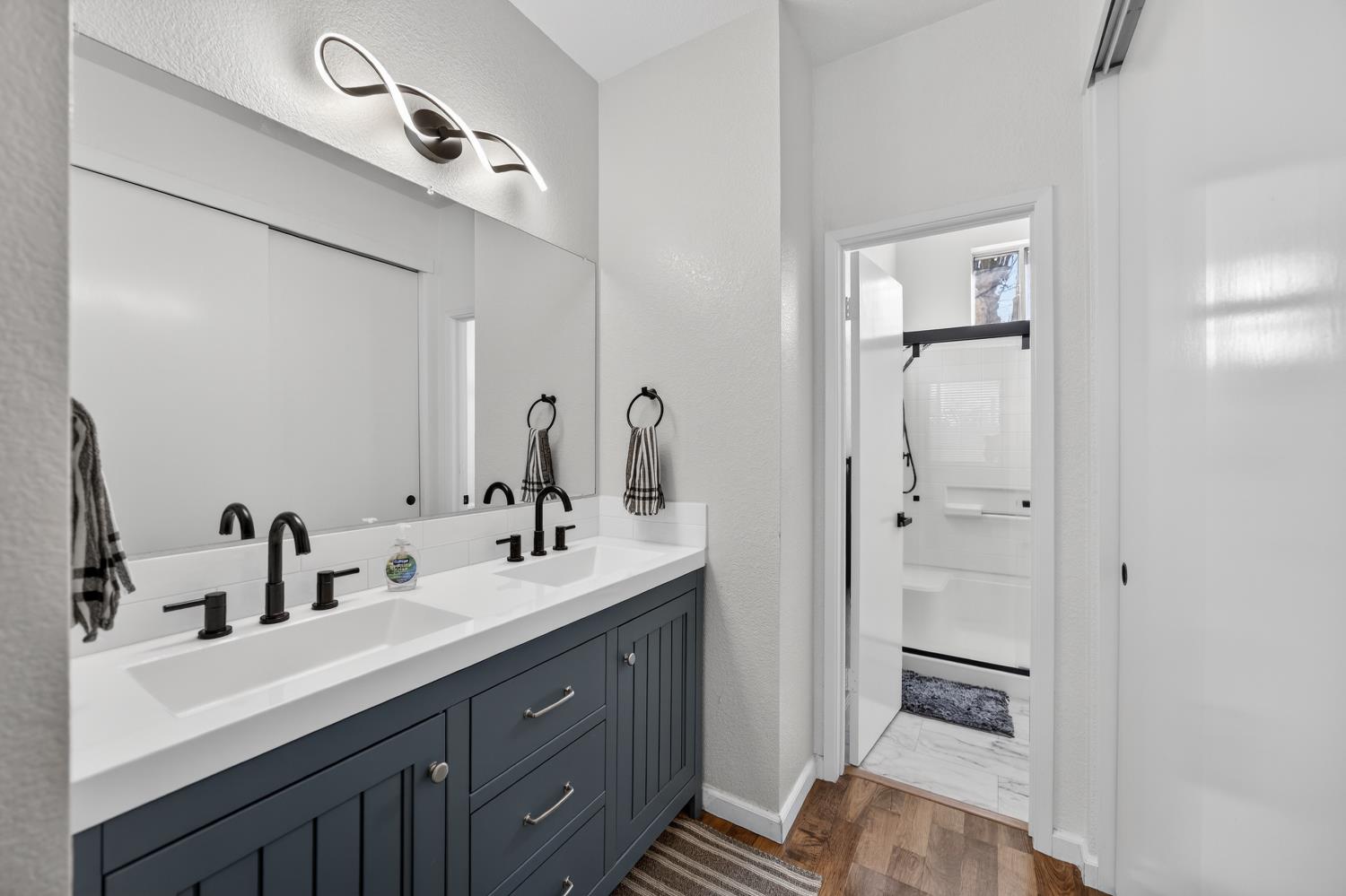 9365 Laguna Pointe Way Elk Grove, CA 95758 - Photo 17 of 24 a bathroom with a double vanity sink a mirror and shower